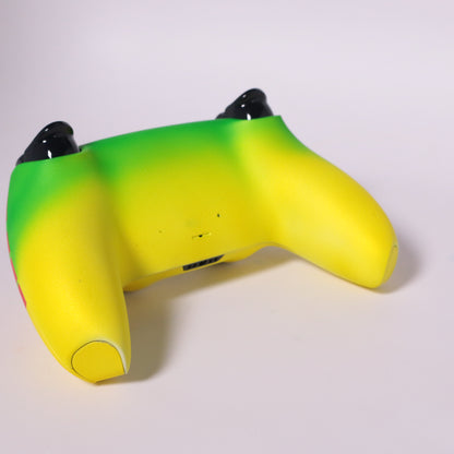 custom-airbrush-painted-dinosaur-theme-ps5-controller-Dino DNA-jeep-Sam Neil-red-yellow-green-TRex A custom PlayStation-style game controller featuring a theme, with a bright yellow body, red and green camouflage patterns, and the  logo on the top center.